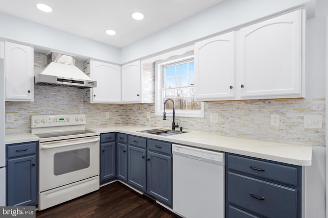 kitchen featuring sink, white cabinets, white appliances, and wall chimney exhaust hood