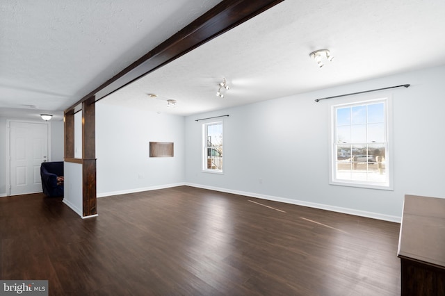 spare room with dark wood-type flooring and a textured ceiling