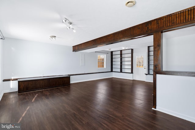 unfurnished room with dark hardwood / wood-style floors and built in shelves