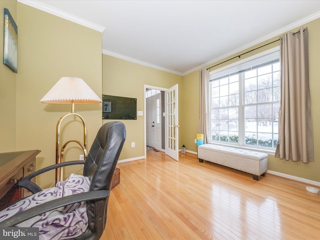 office space with ornamental molding and light hardwood / wood-style floors