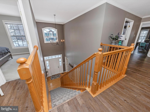 entryway featuring crown molding, a chandelier, and dark hardwood / wood-style floors