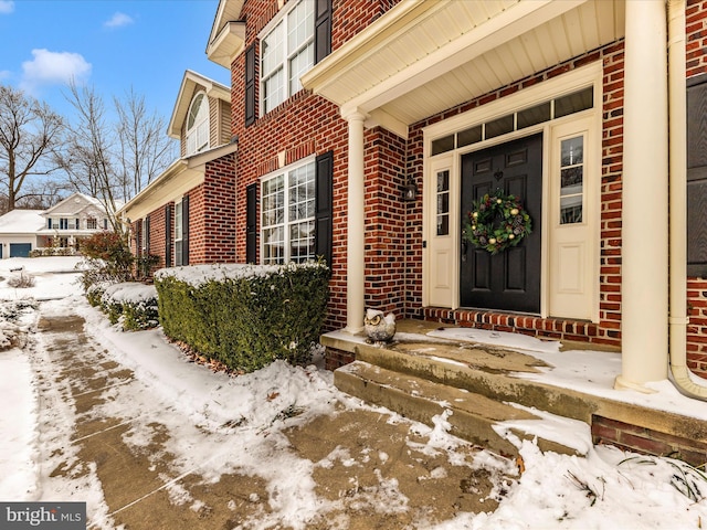 view of snow covered property entrance