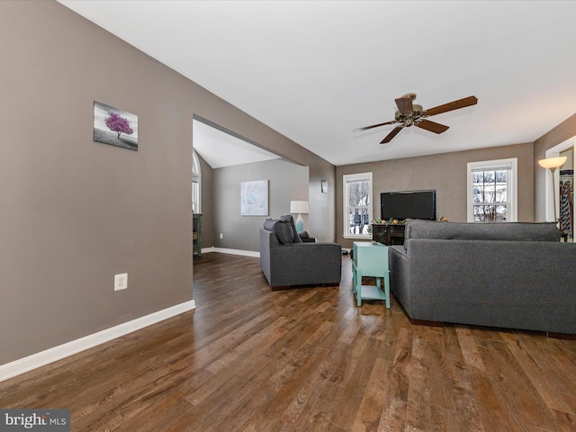 living room featuring ceiling fan and dark hardwood / wood-style floors