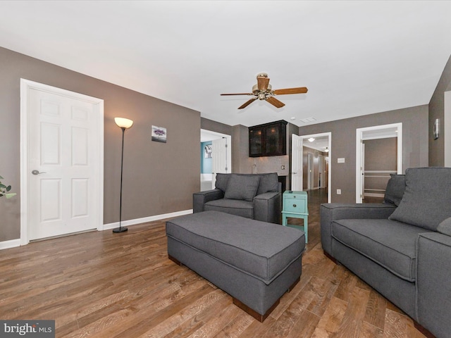 living room with ceiling fan and hardwood / wood-style floors