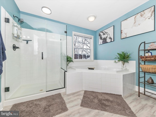 bathroom with hardwood / wood-style floors and plus walk in shower