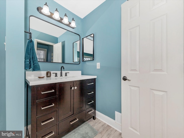 bathroom with hardwood / wood-style flooring and vanity