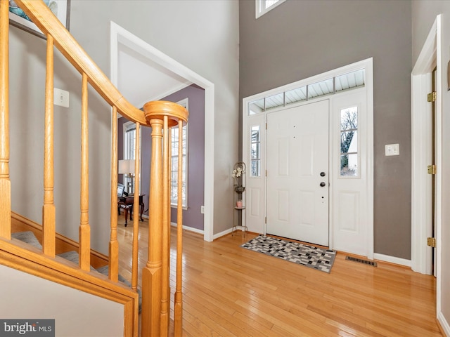 entrance foyer featuring wood-type flooring and a healthy amount of sunlight