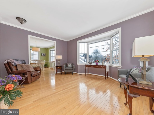 interior space with crown molding and light wood-type flooring