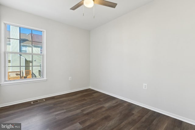 empty room featuring ceiling fan and dark hardwood / wood-style floors