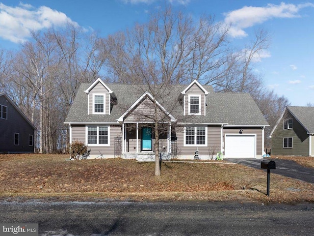 cape cod house featuring a garage