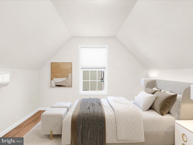 bedroom with wood-type flooring, lofted ceiling, and a wall mounted air conditioner