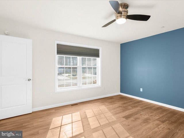 empty room featuring ceiling fan and light hardwood / wood-style floors