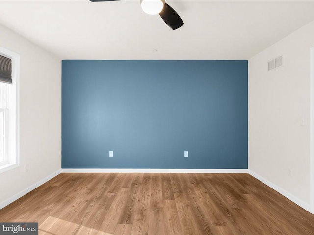 unfurnished room featuring hardwood / wood-style floors and ceiling fan