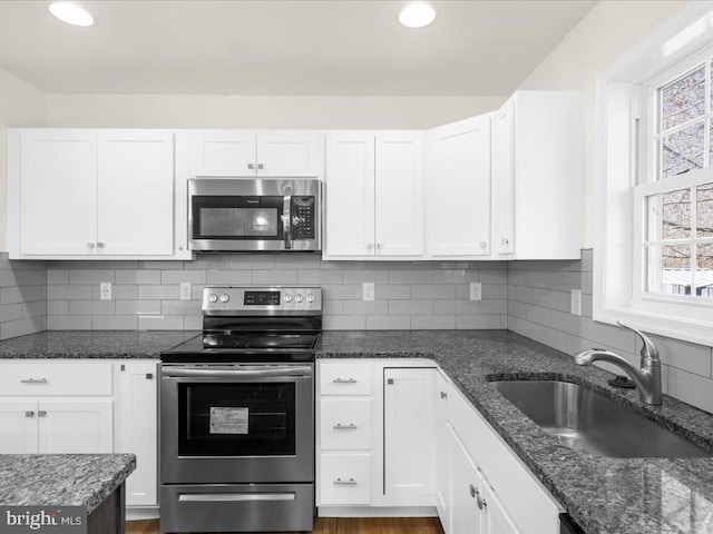 kitchen with white cabinetry, appliances with stainless steel finishes, sink, and a healthy amount of sunlight