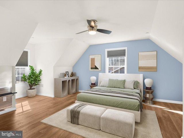 bedroom with hardwood / wood-style floors, vaulted ceiling, and ceiling fan