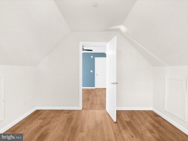 bonus room featuring vaulted ceiling and light wood-type flooring