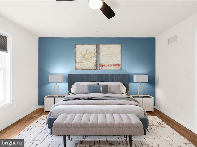 bedroom with light hardwood / wood-style flooring and ceiling fan