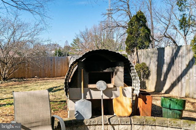 view of outdoor structure with a fenced backyard