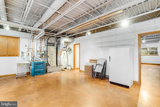 basement with freestanding refrigerator and baseboards