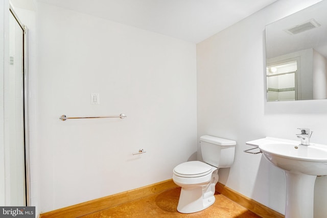 bathroom with baseboards, visible vents, a sink, and toilet