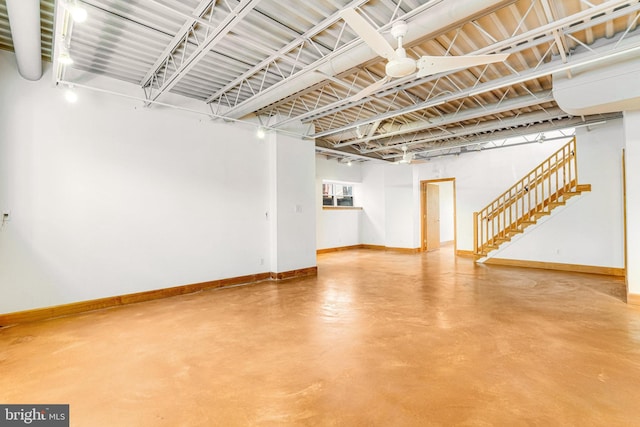 basement with stairway and baseboards