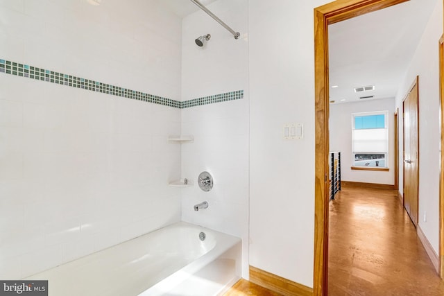 full bathroom featuring baseboards, visible vents, and shower / washtub combination