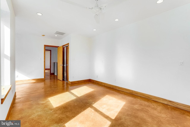 unfurnished room with recessed lighting, concrete floors, and baseboards