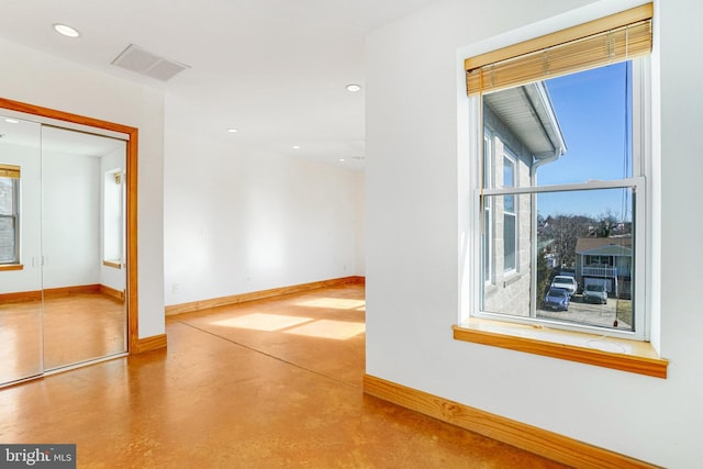 unfurnished room with recessed lighting, visible vents, concrete floors, and baseboards