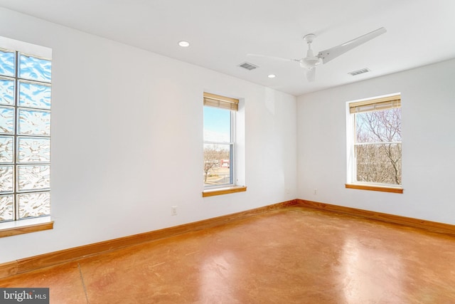 spare room featuring concrete flooring, recessed lighting, visible vents, and baseboards