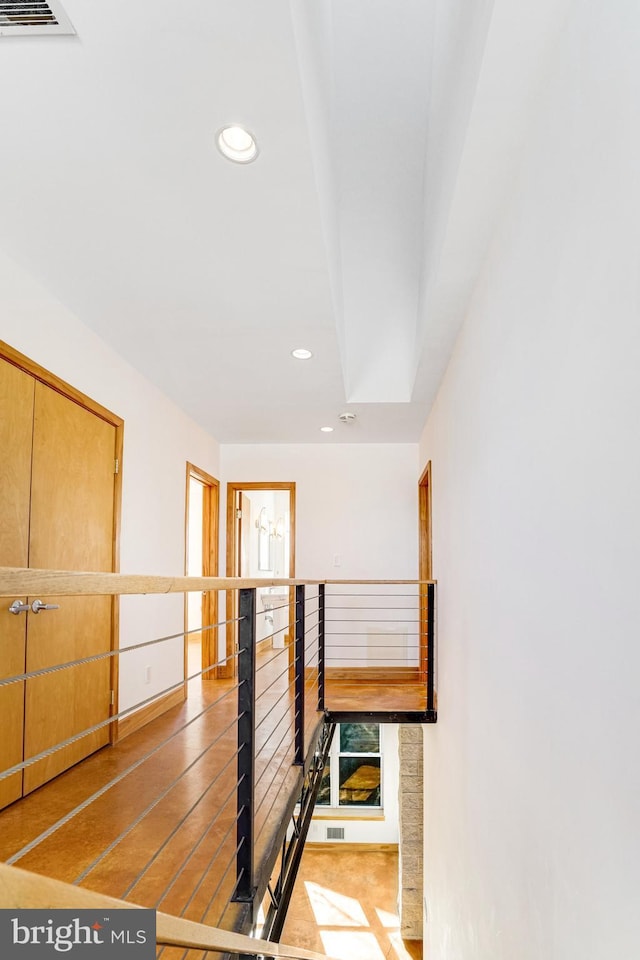 corridor with visible vents and recessed lighting