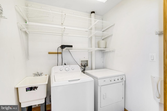 laundry area with washer and dryer, laundry area, and a sink