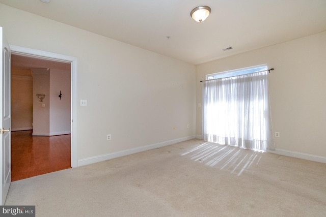 empty room featuring light colored carpet