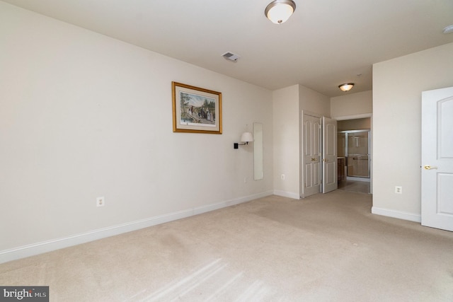 unfurnished bedroom with light colored carpet