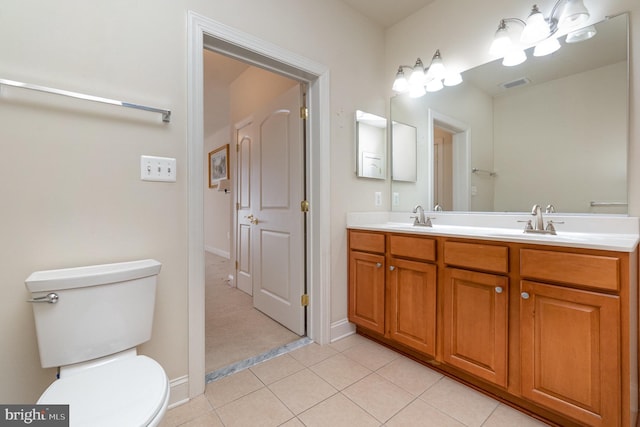 bathroom featuring tile patterned floors, toilet, and vanity