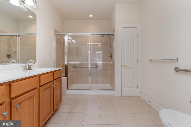 bathroom featuring vanity, toilet, tile patterned floors, and walk in shower