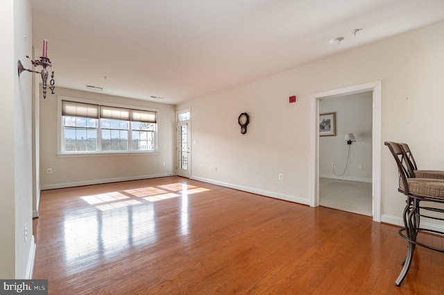 spare room with light hardwood / wood-style flooring