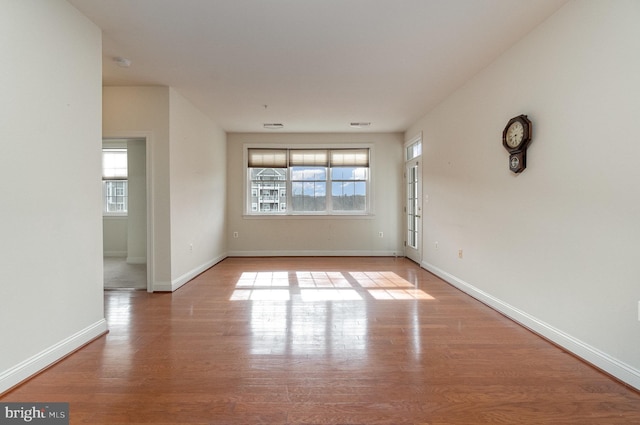 empty room with a healthy amount of sunlight and light wood-type flooring