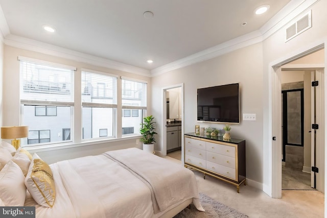 bedroom with ensuite bathroom, light colored carpet, and crown molding