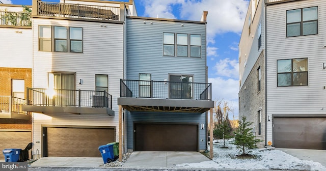 view of front of property with a garage and a balcony