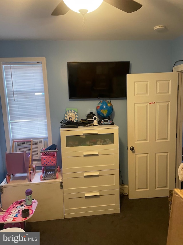 bedroom featuring ceiling fan and dark carpet