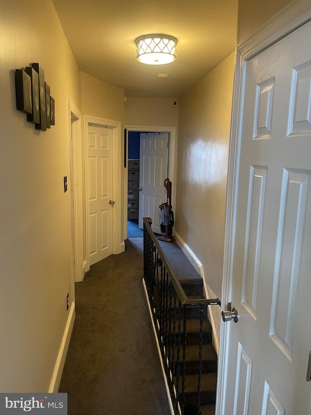 hallway with dark carpet