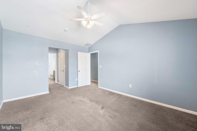 unfurnished bedroom with ceiling fan, vaulted ceiling, and light carpet