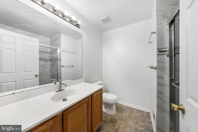 bathroom featuring toilet, walk in shower, and vanity