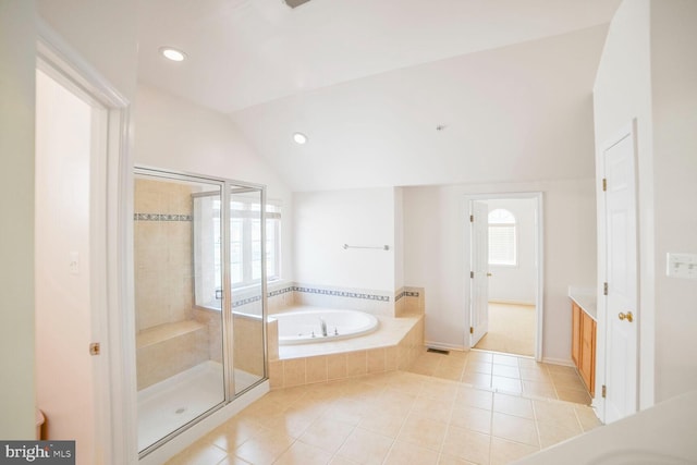 full bathroom featuring tile patterned floors, vaulted ceiling, vanity, a shower stall, and a bath