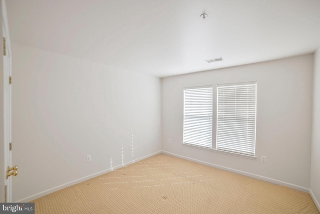 empty room with light carpet, baseboards, and visible vents