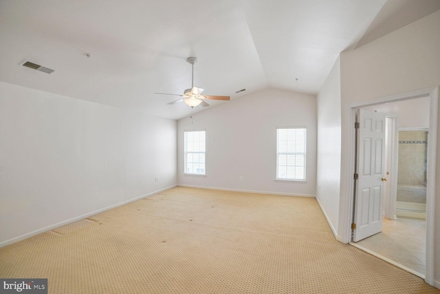 empty room with light carpet, ceiling fan, visible vents, and vaulted ceiling