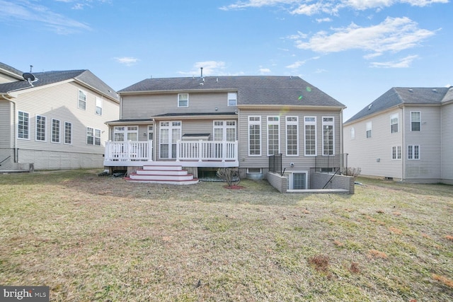 back of house featuring a lawn and a deck