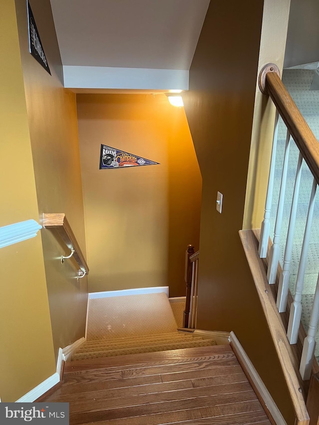 stairs with baseboards and wood finished floors