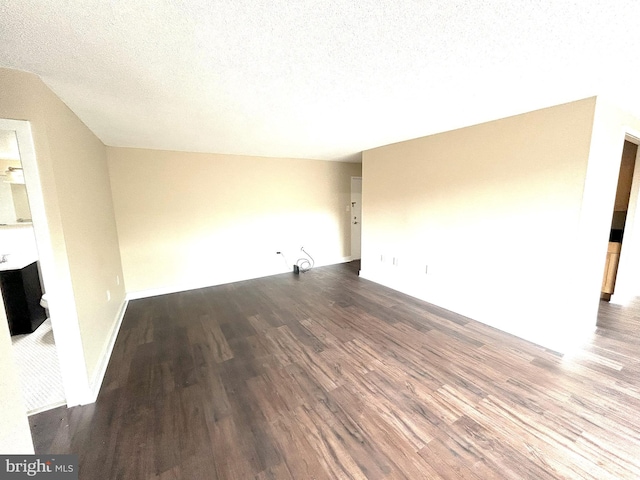 unfurnished living room with hardwood / wood-style flooring and a textured ceiling