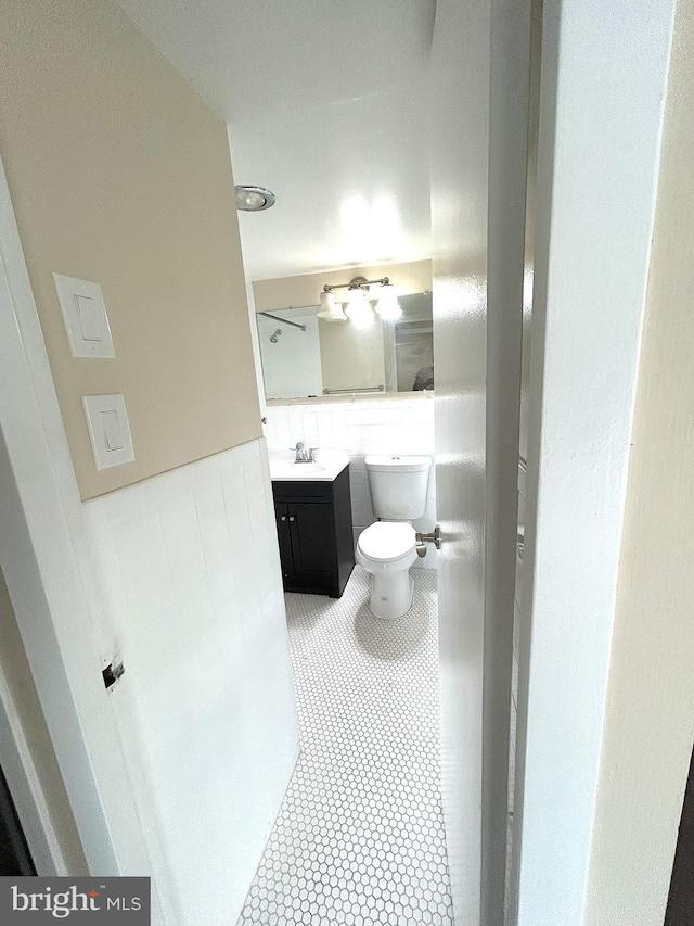 bathroom with tile patterned floors, toilet, and vanity